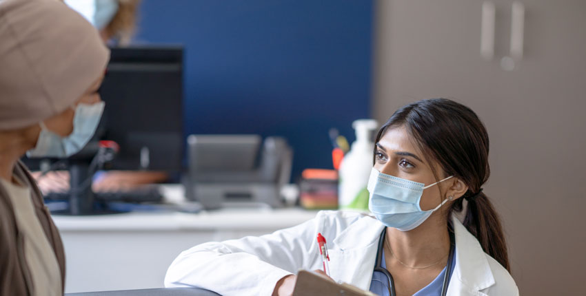 Photo of a health care provider interviewing a female patient 