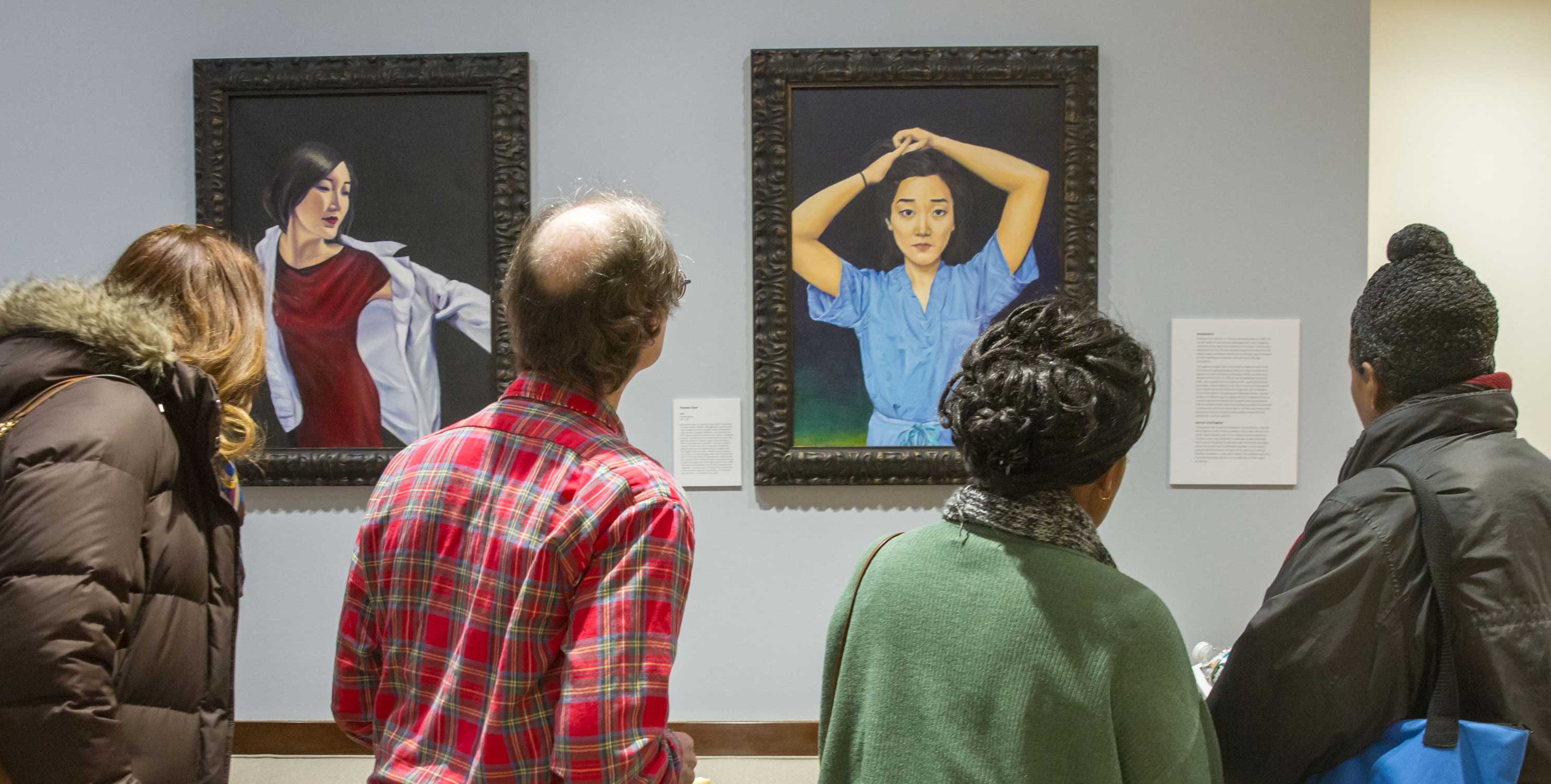 Visitors viewing the Chen paintings in the HMS dean's office.