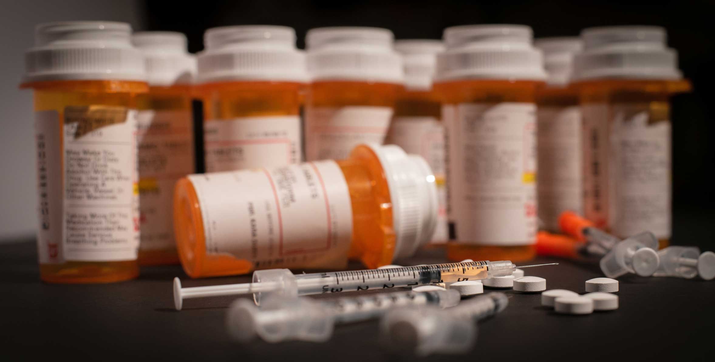 Picture of opioid pill bottle and syringe