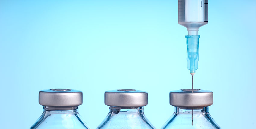Image of 3 vaccine bottles & a syringe 