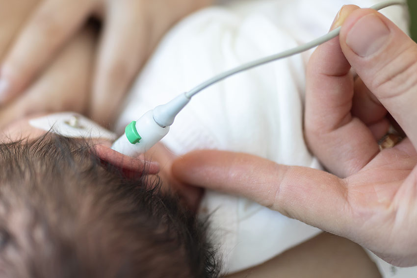 a newborn receiving hearing test