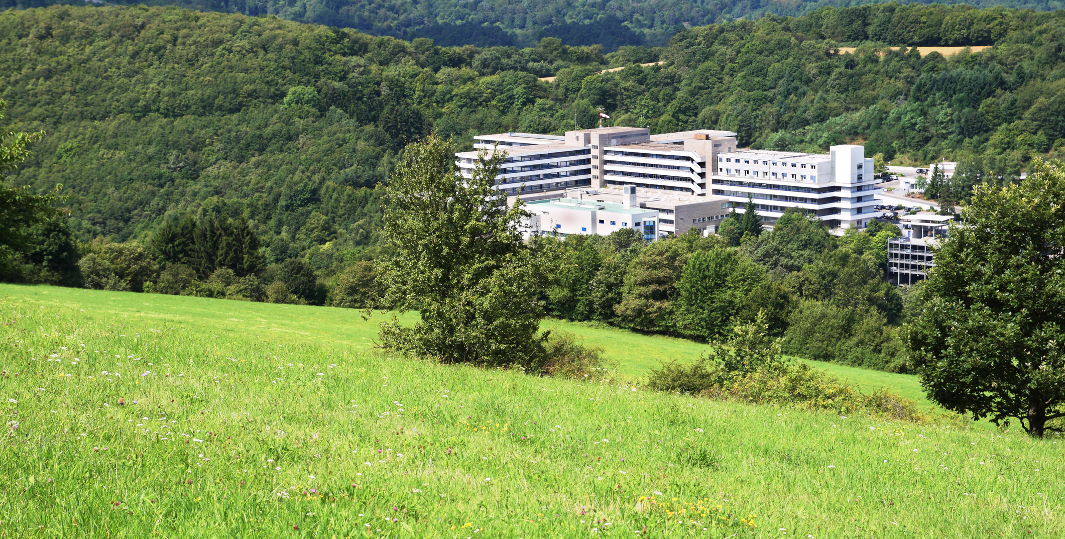 Photo of hospital building in a rural setting in the mountains