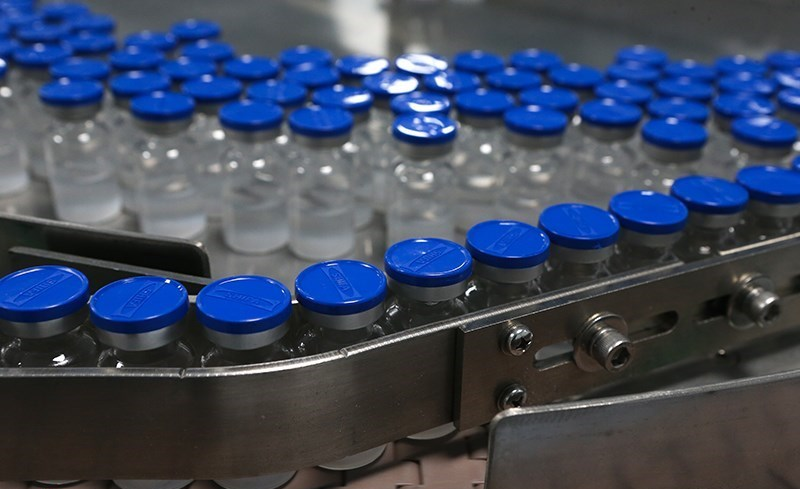 Production line of unlabeled vaccine bottles