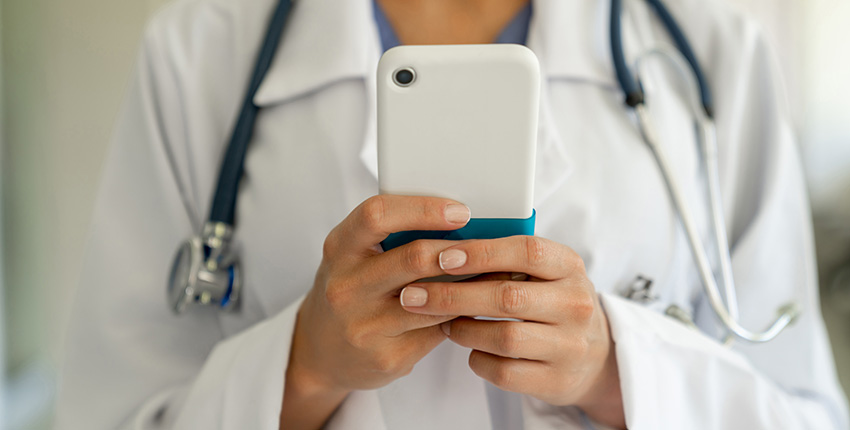 Female physician holding a mobile phone