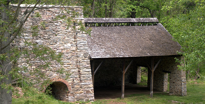 An unoccupied stone building in the woods