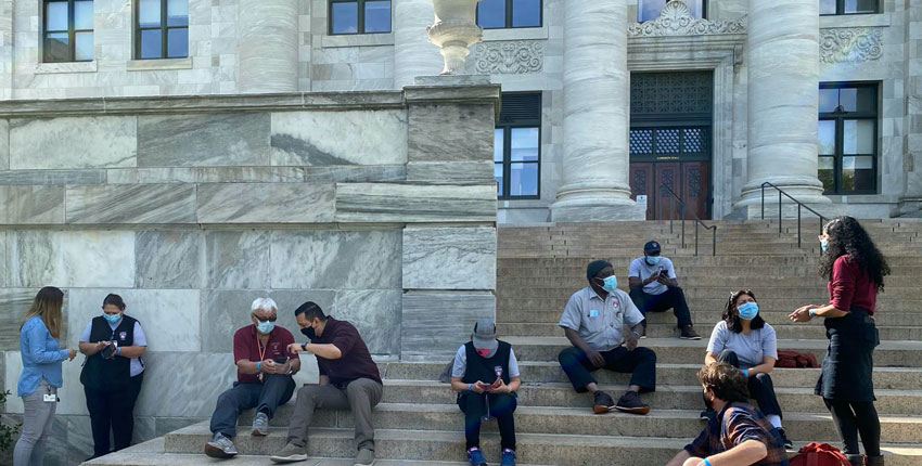 HMS researchers and custodial staff meet on the steps of Gordon Hall on the HMS Quad