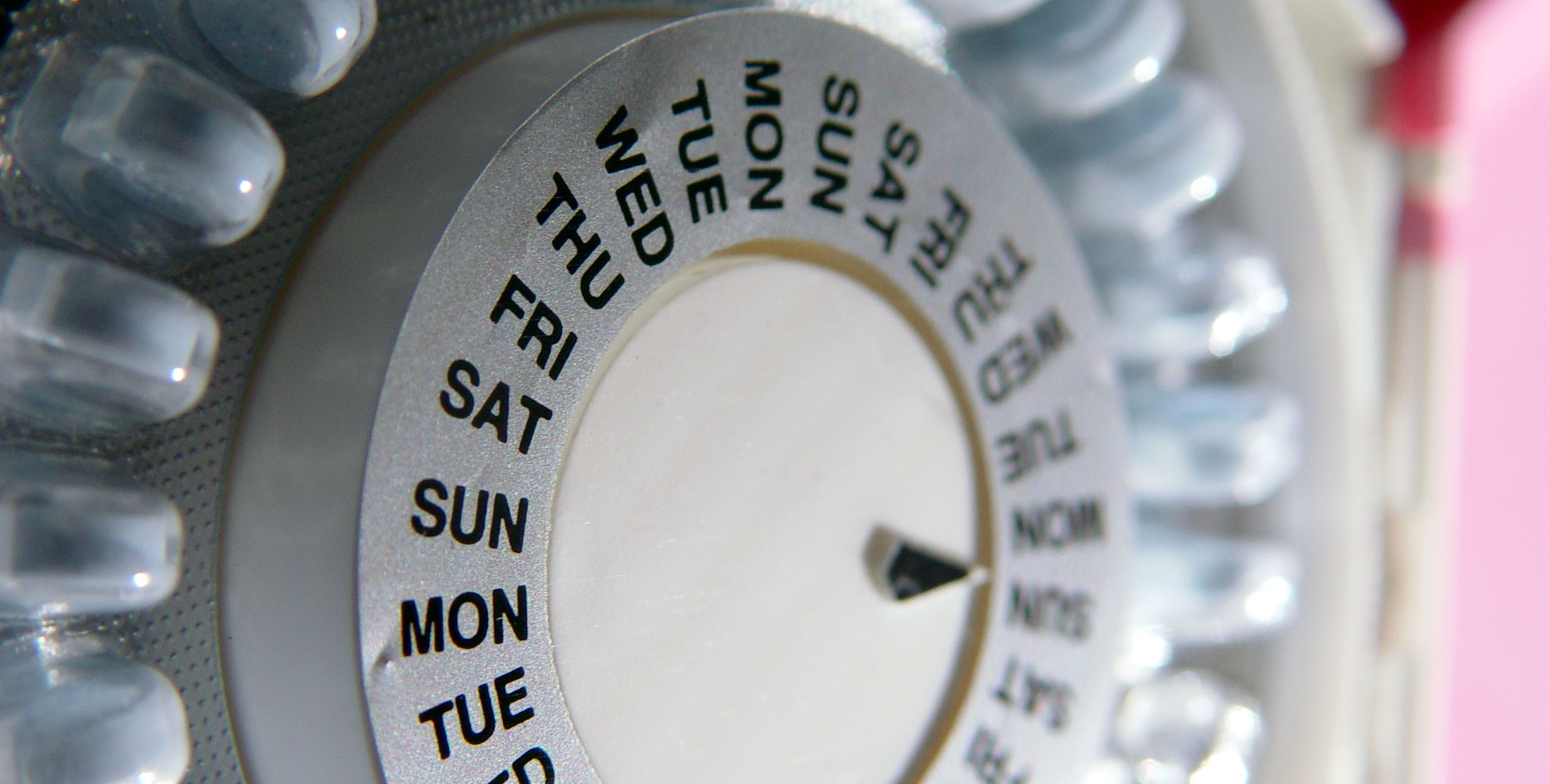 Close-up of a pill organizer listing days of the week.