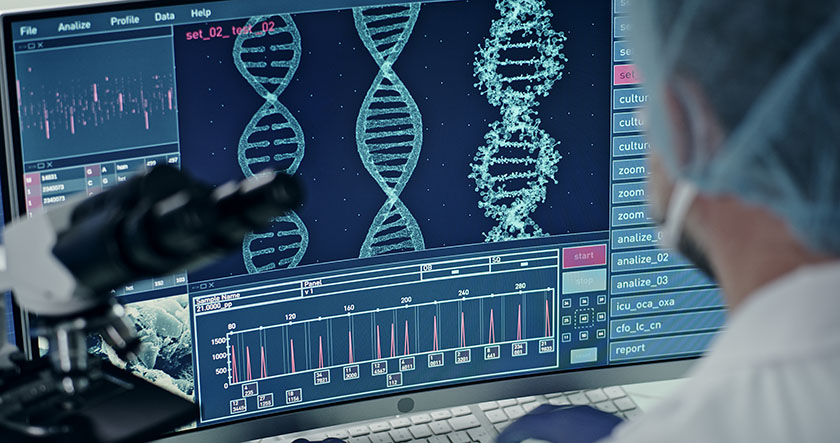 A scientist looks at computer screen showing a DNA sequence