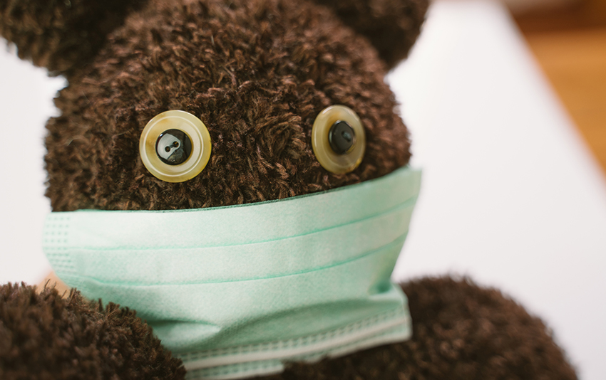 Photo of a teddy bear wearing a surgical mask