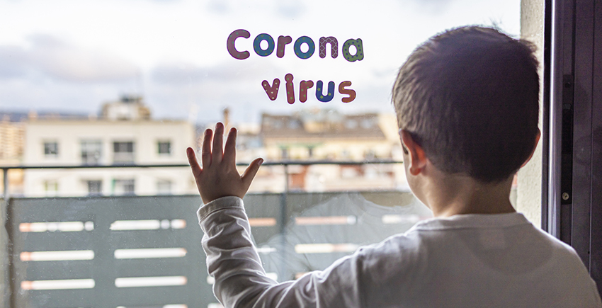 Child silhouetted against hospital window with letter-shaped magnets spelling out Corona virus