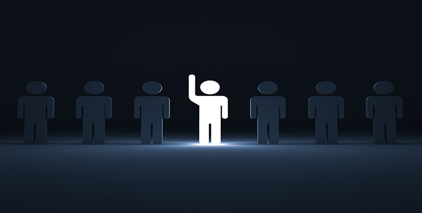 Image of One glowing light man raising his hand among other dim people in the row on dark blue background with shadows