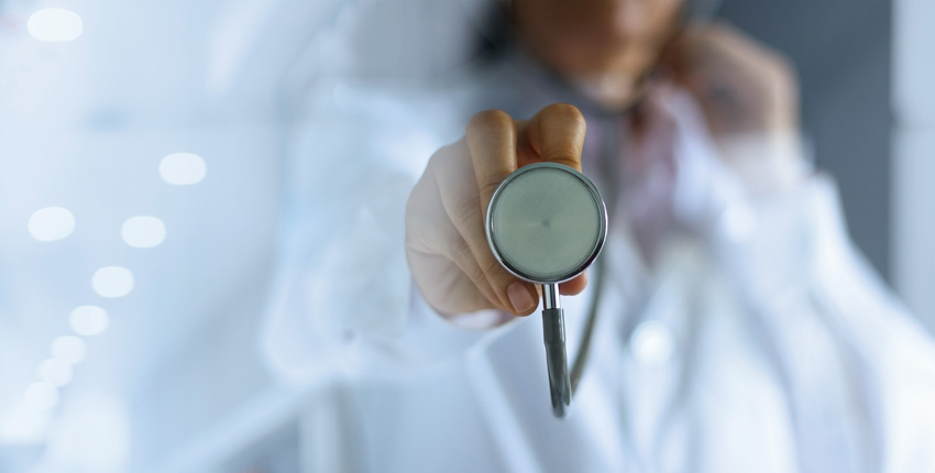 Closeup of a woman holding a stethoscope.