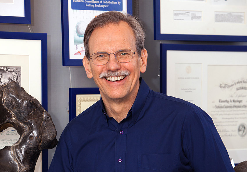 Head shot of a smiling middle-aged white man with glasses and a moustache