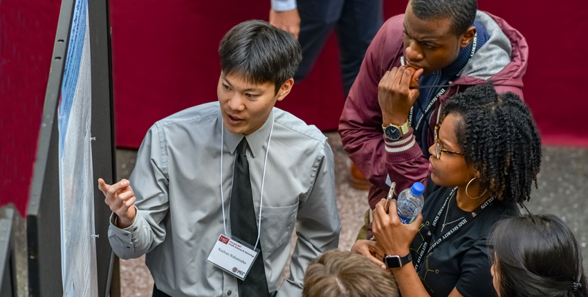 HMS student explaining his research project to other students at the forum 