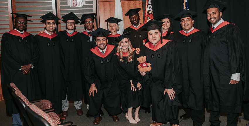 a group of master's degree graduates