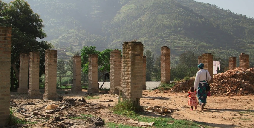 Woman and child walking down dirt road