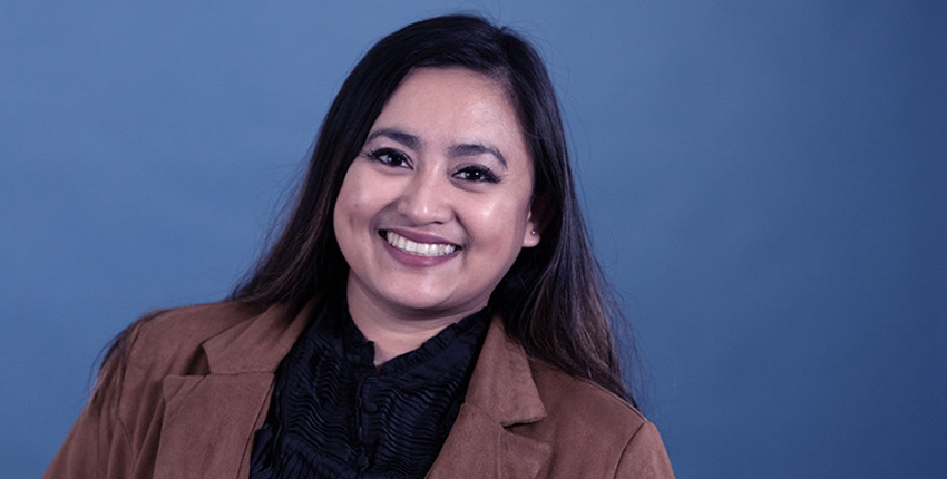 portrait photo of a smiling Filipino-American woman wearing a blazer