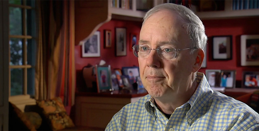 Screen shot of Chris Walsh in a well-decorated room, talking to the camera