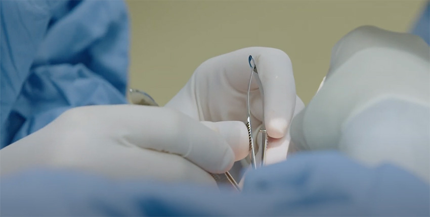 surgeon's hands with implements