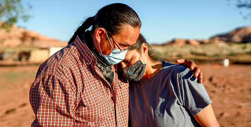 A husband and wife comfort one another during the Coronavirus shutdown on the Navajo nation in Arizona