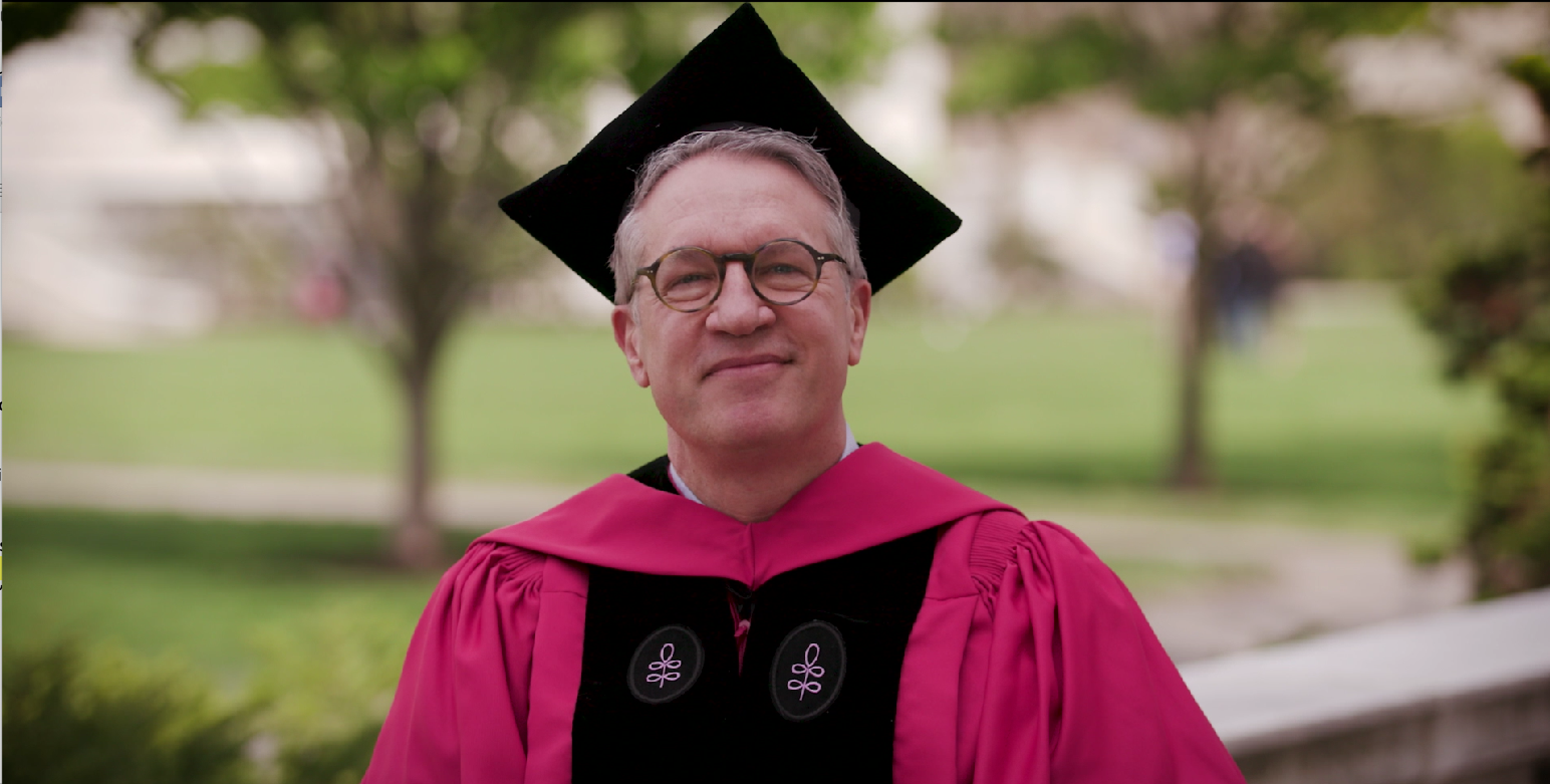 Dr. Giannobile, dressed in academic regalia, speaking outdoors