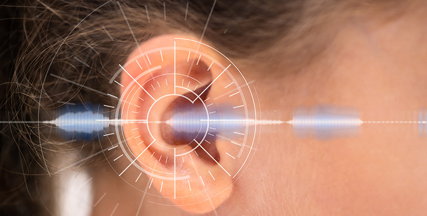 Close up of a white child's ear with a sound wave overlaid digitally