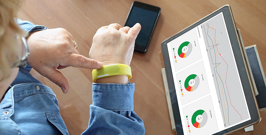 woman's wrist with smart watch and tablet with health data