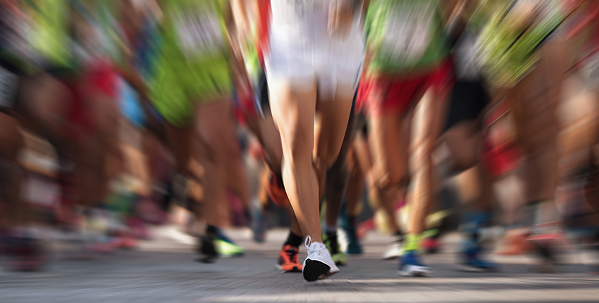 blurred image of runners' legs