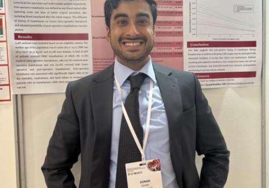 Adnan Khan with a poster at a conference
