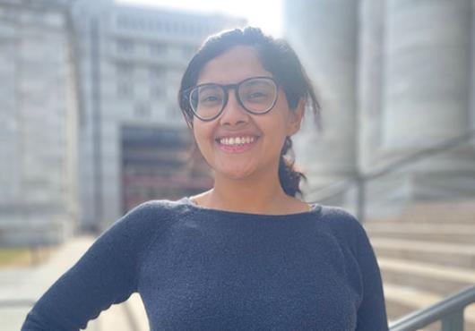 Payel Ganguly standing in front of the steps to Gordon Hall