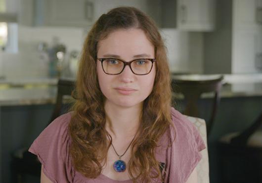 Jessica Chaikof sitting in a kitchen, looking at the camera