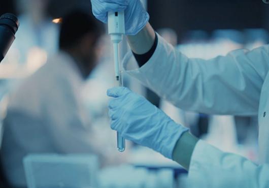 researcher in white coat working in laboratory