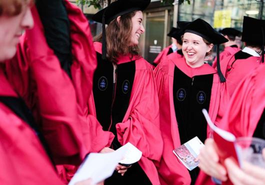 candid photo of group of PhD graduates wearing caps and gowns