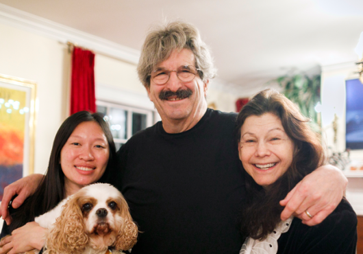 Gary Ruvkun with daughter Victoria Ruvkun (left), dog Barnaby, and wife Natasha Staller the morning of the announcement at their home in Newton.