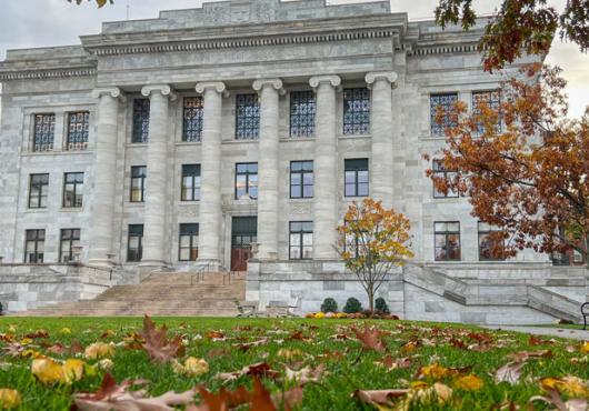 Front view of Gordon Hall surrounded by vibrant fall foliage.