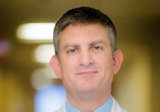 Alt text: Portrait photo of Brian Wolpin in a white coat.