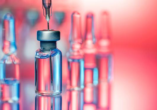 Stylized photograph of unlabeled bottles of vaccine