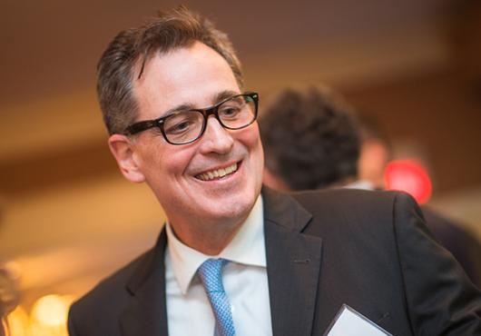 Head shot of a man in glasses and suit