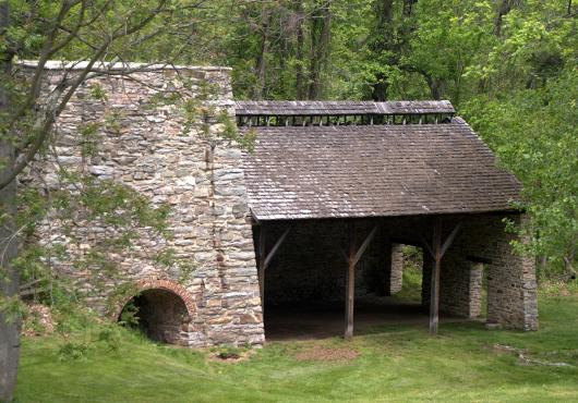 An unoccupied stone building in the woods