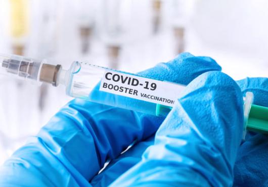 gloved hand with syringe and covid treatment 