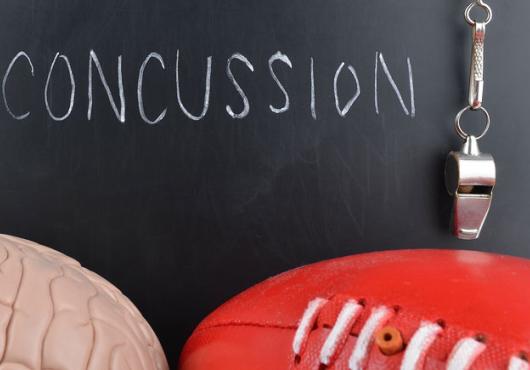Illustration of a chalkboard that reads "Concussions" with a brain and a football nearby