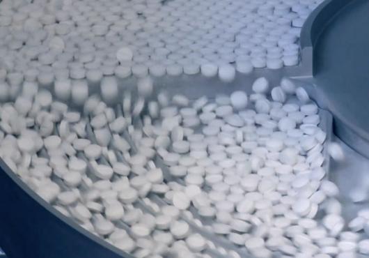 Shot of pills being processed in a factory