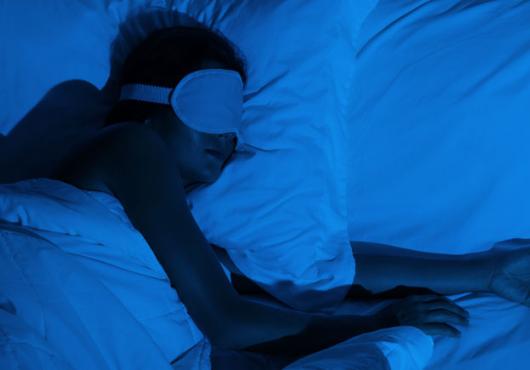 person in deep sleep wearing eye mask