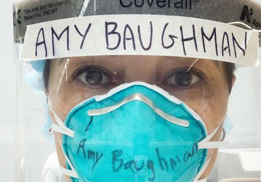 Photo of Amy Baughman MD in full COVID PPE, mask and head gear