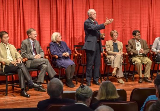 Dean Daley with symposium participants on stage.