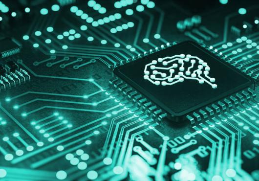 A teal computer circuit board with a simple line drawing of a brain in the center