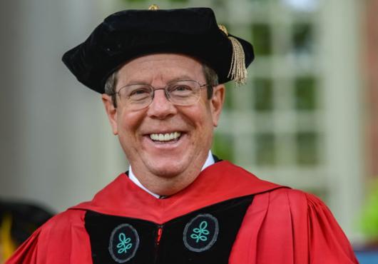 Photo of Hundert at graduation in cap and gown