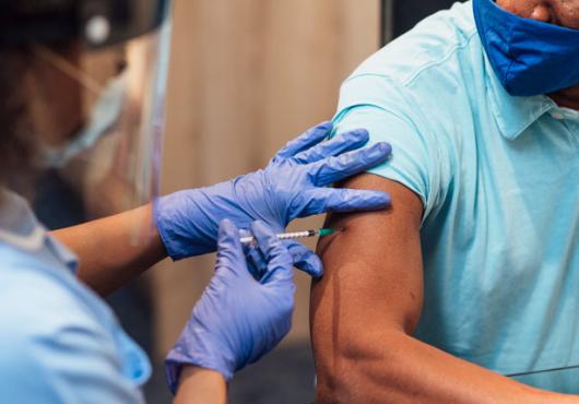 Image of a healthcare worker vaccinating a patient