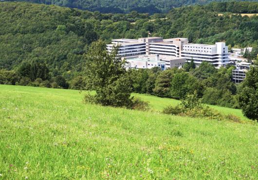 Photo of hospital building in a rural setting in the mountains
