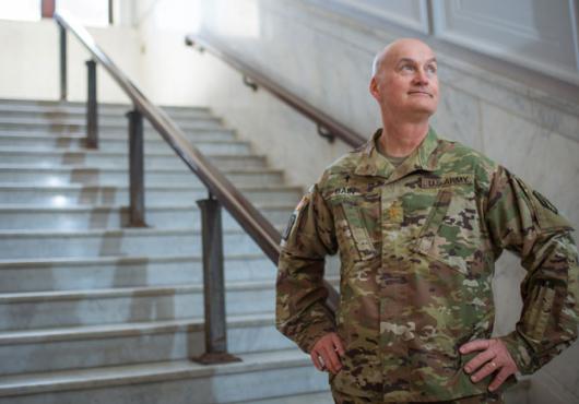 Bain wearing military uniform standing on marble steps with hands on hips